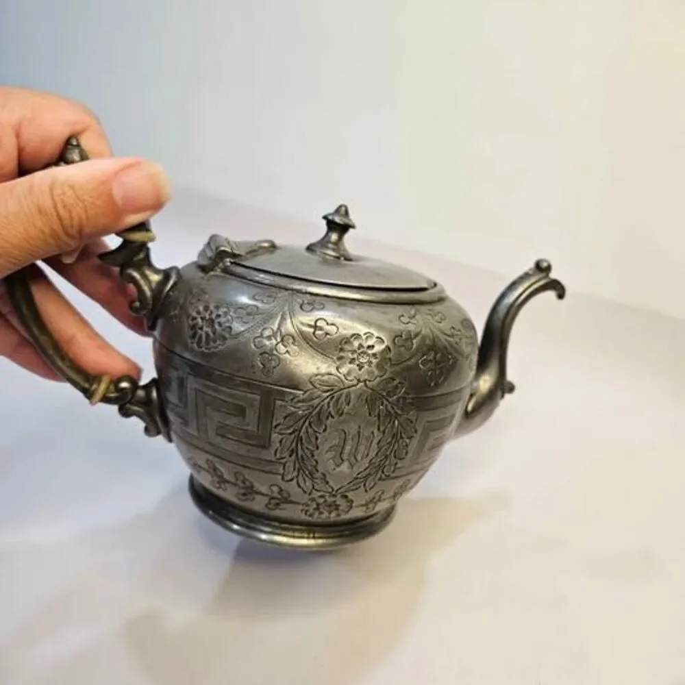 Antique silver-plated teapot Greek key pattern & embossed floral motifs.